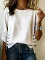 Detailed view of white cotton linen top featuring decorative side button accents - S / Tops / White