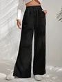 Detail of black high-waisted corduroy trousers with split hem and vertical texture. - 3XL / Bottoms / Black