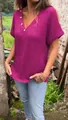 Detailed view of fuchsia knit V-neck T-shirt featuring decorative wooden buttons - S / Tops / Purple