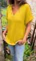 Close-up of women's yellow waffle knit V-neck T-shirt with stylish button details - M / Tops / Yellow
