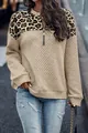 Detail view of women's leopard print patchwork sweatshirt with quilted texture and zipper - S / Tops / Earthy Yellow