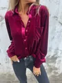 Front view of a stylish burgundy velvet button-down shirt with a chest pocket on model - S / Tops / Fuschia