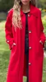Detail view showing the vibrant red wool fabric and large decorative buttons of the coat - Red