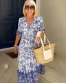 Detailed view of women's bohemian blue and white floral print maxi dress on model - S / Dresses / Blue