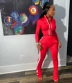 Red women's sporty two-piece tracksuit set with white side stripes and zipper top - Red