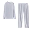 Detail view of a white long-sleeved loungewear set featuring a soft fabric texture. - S / Top And Bottom / White