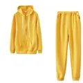 Detail view of a yellow two-piece women's tracksuit with zip-up hoodie and sweatpants - S / Top And Bottom / Yellow
