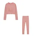 Solid pink two-piece sports set featuring long-sleeved crop top and matching leggings - Pink