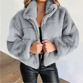 Close-up of a grey plush faux fur jacket with a high collar and front zipper detail - XL / Tops / Gray
