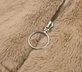 Close-up detail of a circular silver metal zipper pull on a soft camel faux fur plush jacket. - S / Tops / Khaki