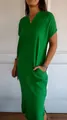 Detailed view of a loose green V-neck linen dress featuring handy pockets and side slits. - S / Green