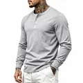 Detail view of a grey men's long-sleeved Henley shirt with button placket and ribbed cuffs - M / Tops / Light Gray