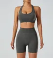 Front detail of a seamless grey halter-neck sports bra and high-waist fitness shorts set - Dark Gray