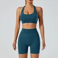 Seamless teal yoga set featuring a halter sports bra and high-waisted yoga shorts - Dark Green