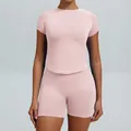 Slim fit seamless pink yoga set for women featuring short sleeve top and shorts - XS / Top And Bottom / Shorts Set / Pearl Pink