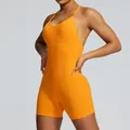 Athletic orange seamless one-piece yoga bodysuit for women with ribbed texture and backless design - Orange