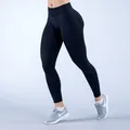Black high-waisted seamless yoga leggings with scrunch butt lifting design for fitness. - Black
