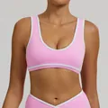 Pink sports bra with white contrast trim and wide shoulder straps for yoga and fitness. - S / Tops / Sakura Pink