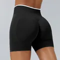 High-waisted seamless peach lift yoga shorts in black and white color block - Black