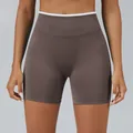 High-waisted brown seamless yoga sports shorts featuring a white contrast waistband - Mocha