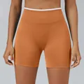 Premium high-waist seamless yoga shorts in burnt orange featuring a white contrast trim waistband - Pumpkin Orange