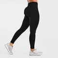Side view of seamless black peach butt lifting yoga leggings with high waist design - Black