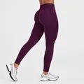 Close-up of purple high-waist seamless leggings with peach butt design for gym - XS / Bottoms / Midnight Purple