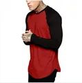 Detailed side view of a red and black raglan long sleeve t-shirt on a male model. - M / Tops / Red