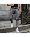 Detailed view of grey plaid slim-fit casual trousers on male model in street style. - 3XL / Bottoms / Dark Gray