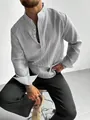 Detailed view of men's grey striped shirt featuring a mandarin collar and textured fabric - M / Tops / Black
