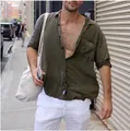 Detail view of men's olive green cotton linen shirt with chest pocket and lapel - Green