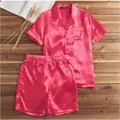 Detailed view of men's pink satin pajama set on a rustic wooden surface - M / Top And Bottom / Red