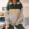 Detail shot of the color-block half-zip sweatshirt featuring yellow Michigan print. - M / Tops / Letter Green