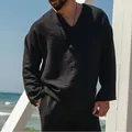 Detail view of a black long-sleeve linen shirt for men with a casual V-neck design - S / Tops / Black