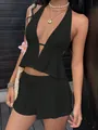 Close-up of a stylish black two-piece summer set featuring a halter neck and shorts - Black