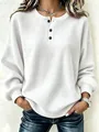 Detailopname van wit sweatshirt met wafelstructuur, zwarte knopen en ronde hals. - S / Tops / Wit
