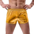 Macro view of men's shiny metallic gold loose casual summer shorts with elastic waist - M / Bottoms / Yellow