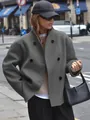 Detail view of a grey double-breasted woolen coat in a chic casual British street style - Dark Gray