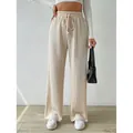 Pantalones de punto con textura de pernera ancha y cintura alta con cordón en color crema. - S / Bottoms / Albaricoque