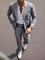 Detailed view of the fabric texture and slim cut of a grey tailored men's blazer. - S / Top And Bottom / Dark Gray
