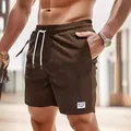 Bequeme braune Cord-Shorts für Herren mit weißem Kordelzug und elastischem Taillenbund - S / Unterteile / Kaffeebraun