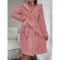 Close-up view of a cozy pink coral fleece hooded bathrobe featuring premium embossed texture - S / Tops / Pink