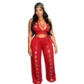 Detailed view of red two-piece set featuring oversized silver eyelets and wide leg pants. - S / Top And Bottom / Red