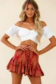 Close-up of white off-shoulder crop top with ruffled sleeves and red printed skirt - S / Tops / White