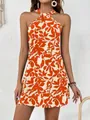 Front view of sleeveless halter neck mini dress with vibrant orange leaf print - S / Bottoms / Orange Red