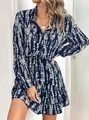 Close-up of a stylish blue and white patterned long-sleeved dress with ruffled hem detail - S / Dark Blue