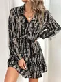 Detailed shot of woman wearing a stylish long-sleeved V-neck ruffled dress with pattern - S / Black