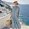 Detail view of a loose light blue maxi dress with bow tie neck and side pockets - S / Blue