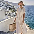 Elegant white summer dress with bow detail and pockets in scenic coastal setting - S / Beige