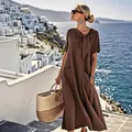 Elegant brown short-sleeved maxi dress with bow detail and side pockets in coastal setting. - S / Coffee